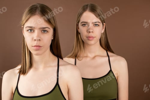 Preview: Serene twins in underwear tanktops looking at camera