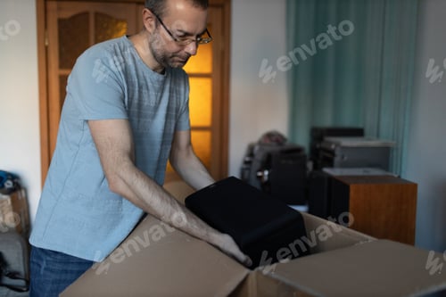Preview: Entrepreneur online shopping packaging speaker in box for delivery at home.