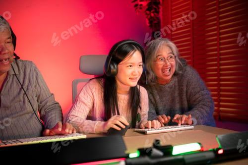Preview: Happy grandparents playing games with grandchildren in in a neon lit room