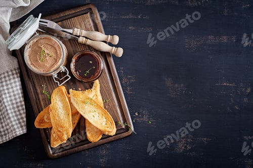 Preview: Chicken homemade liver paste or pate in glass jar with toasts and lingonberry jam with chili.