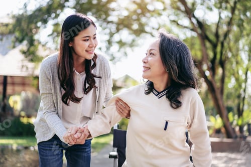 Preview: Senior on wheelchair and daughter family, Young asian woman helping disabled mother to get up