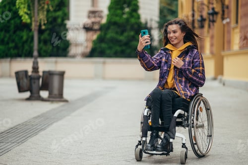 Preview: Woman with disability taking a selfie with her smartphone while out in the city