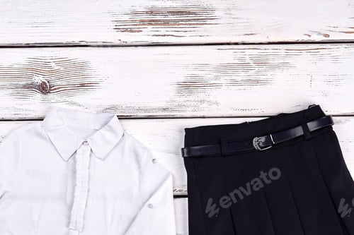 Preview: White Blouse and Black Skirt on Wood