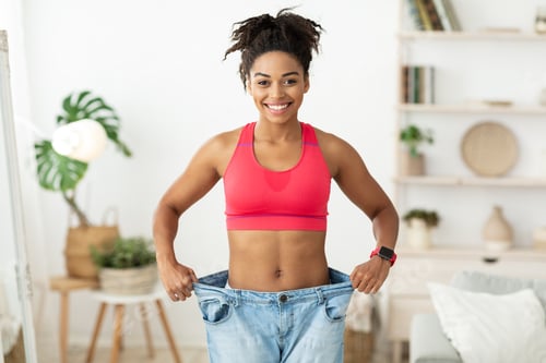 Preview: Joyful Slim Black Girl Wearing Old Big Jeans Standing Indoors