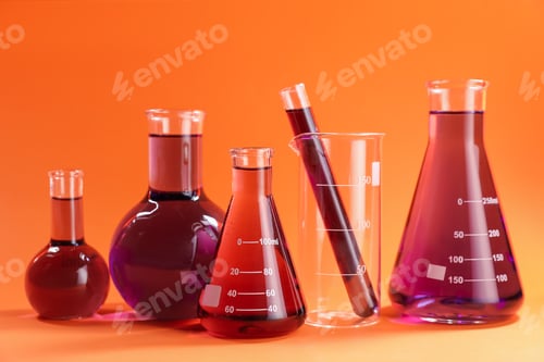 Preview: Laboratory glassware with red liquid on orange background