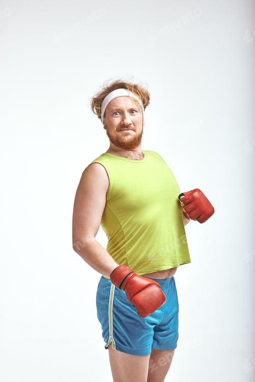 Preview: Red haired, bearded, plump man wearing sportswear and red boxing gloves