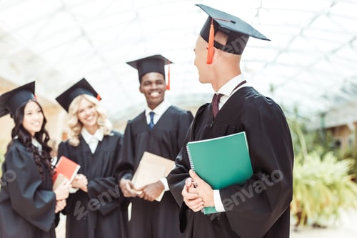 Preview: group of graduated multiethnic students with notebooks