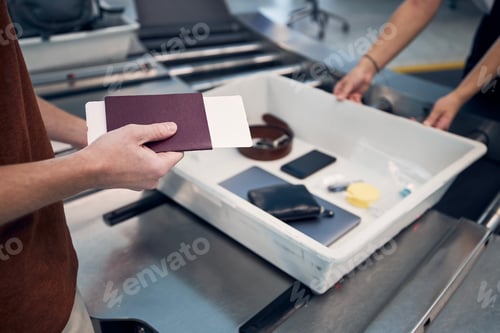 Preview: Passenger holding passport at airport security check