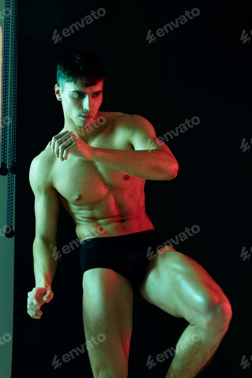 Preview: sexy athletes in black shorts posing on isolated background
