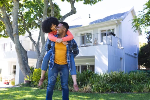 Preview: Happy african american couple riding piggyback in sunny garden, copy space
