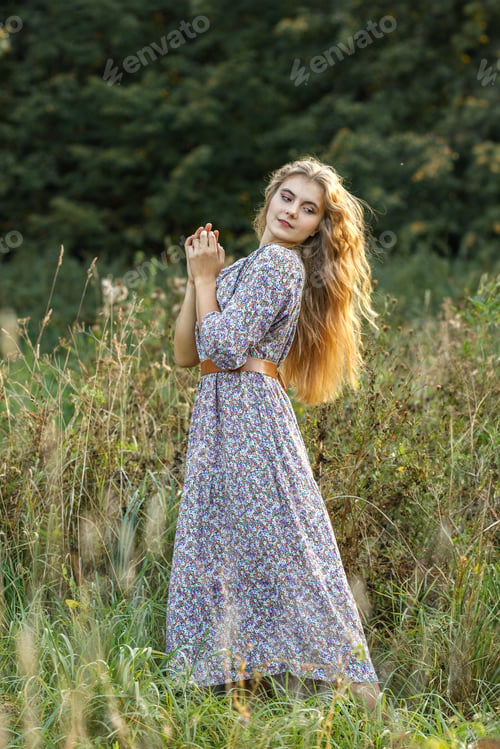Preview: Happy young blonde woman with long hair in nature outdoors in autumn