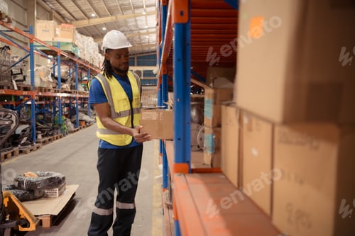 Preview: Young man working in warehouse, This is a freight transportation and distribution warehouse.