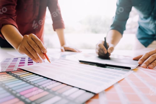 Preview: Co-worker graphic designer working with partnership choosing color on desk in modern office.