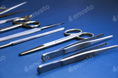 Preview: Closeup shot of a medical dissection kit on a blue surface