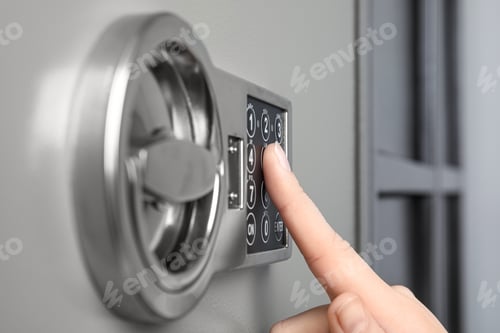 Preview: Woman opening steel safe with electronic lock, closeup
