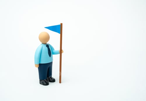 Preview: Businessman with blue flag. The leader shows leadership qualities and sets himself goals to achieve.