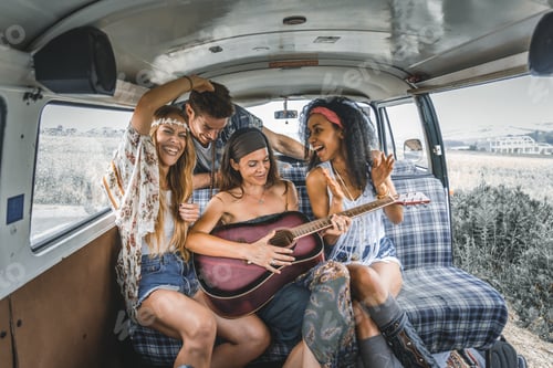 Preview: Happy friends driving a vintage minivan