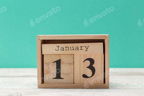 Preview: wooden cube shape calendar for january 13 on wooden tabletop