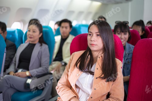 Preview: Group of passengers sitting at seat on airplane during flight