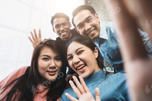 Preview: Friends watch sports on TV, cheer and celebrate. Happy diverse asian friend supporters fans sit on