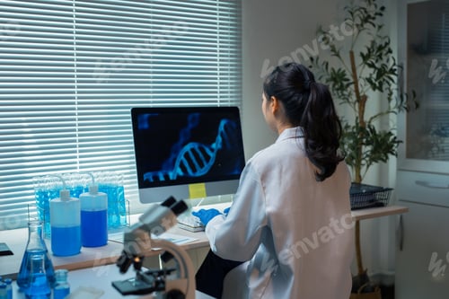 Preview: Female scientist researching DNA sequencing on computer in laboratory