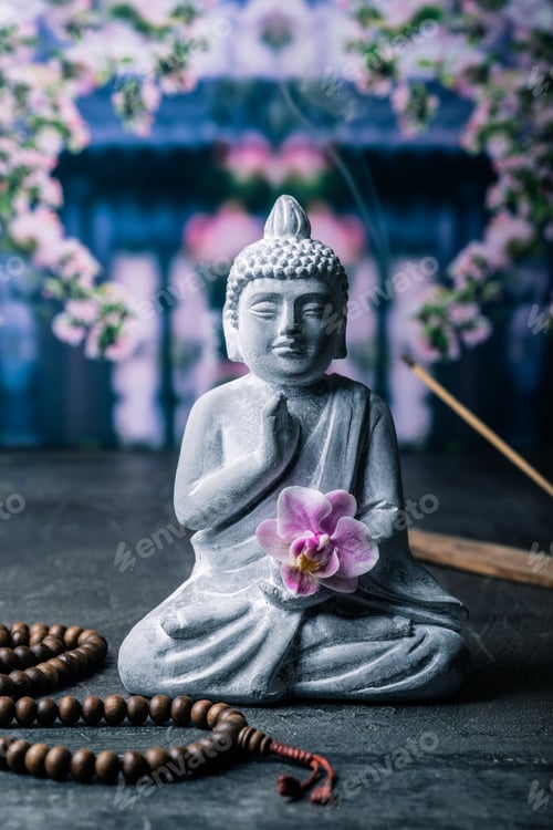 Preview: stone statue of buddha on a stone window sill surrounded by flowers and smoke - asian celebrations