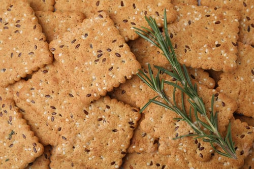 Preview: Rosemary on cereal crackers with flax and sesame seeds, top view