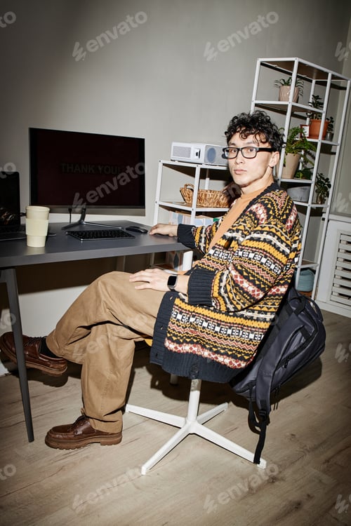 Preview: Portrait of Young Adult Man Sitting at Desk Using Computer Monitor