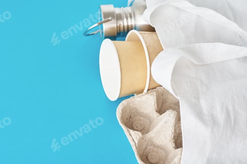 Preview: Eco friendly reusable items on natural shopping bag.