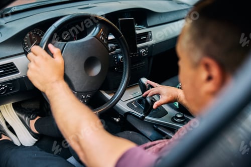 Preview: Close-Up of Person Driving A Car with Focus on Hand