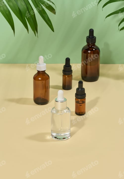 Preview: Glass bottles for cosmetics, oils with a pipette on a beige background