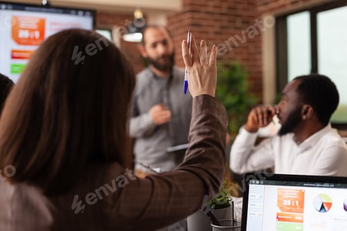 Preview: Businesswoman having rising hand having marketing question during business meeting