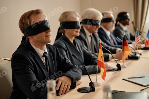 Preview: Group of Middle Aged Multiethnic Businesspeople Sitting Blindfolded at Conference
