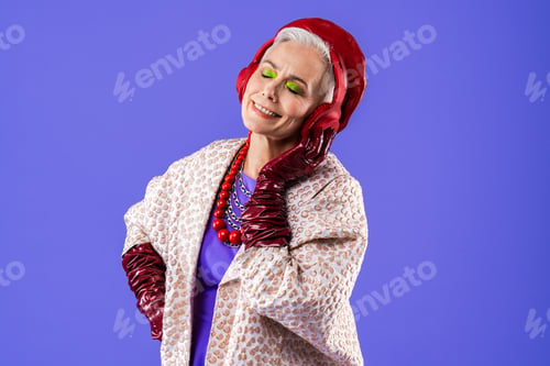 Preview: Happy and funny senior old woman on colorful background