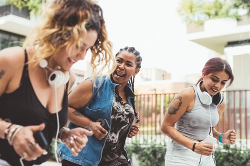 Preview: Three women friends outdoor listeninbg music dancing