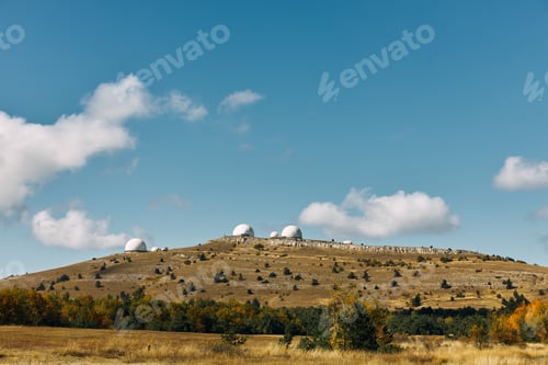 Preview: Exploring the Universe Three Telescopes on Hilltop in Field under Blue Sky on Scientific Expedition