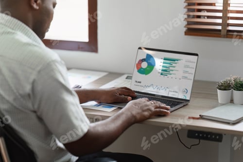 Preview: American African Businessman research and analysis with financial graph at office. Strategy, chart