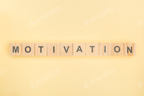 Preview: top view of motivation lettering made of wooden cubes on yellow background