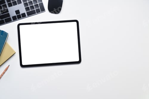 Preview: Digital tablet with blank empty screen, keyboard, mouse and notebook on white office desk