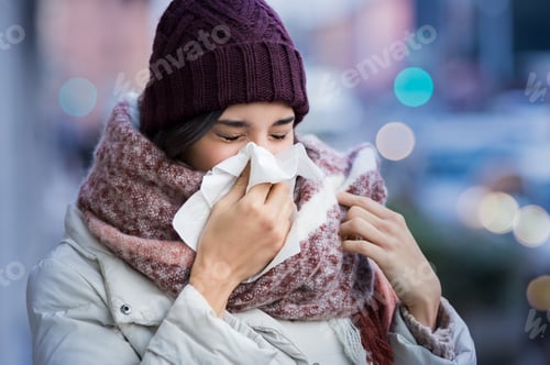Preview: Woman blowing nose outdoor