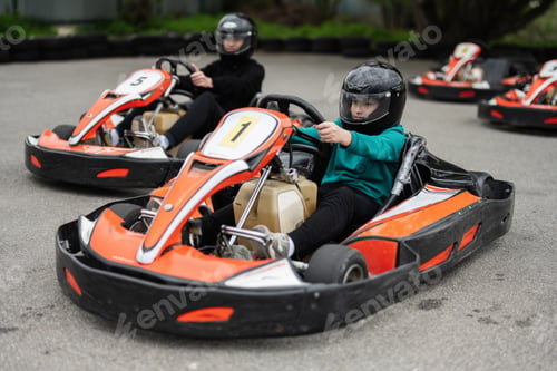 Preview: Children Enjoying Go-Kart Racing Outdoors for a Fun and Exciting Adventure