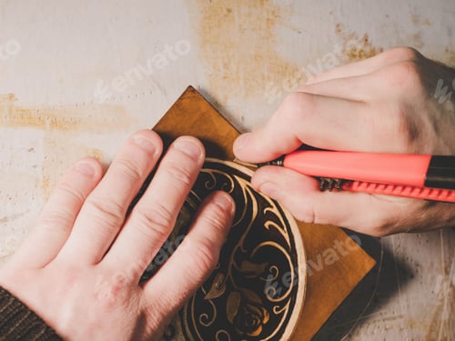 Preview: Close up hands of unrecognizable leather craftsman working on measurements in patterns in local
