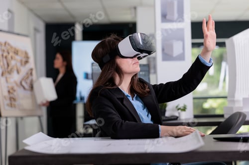 Preview: Architect in ar helmet touching virtual building model