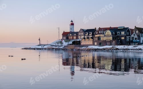 Preview: Lighthouse of Urk during winter with snow in the Netherlands on a sunny day