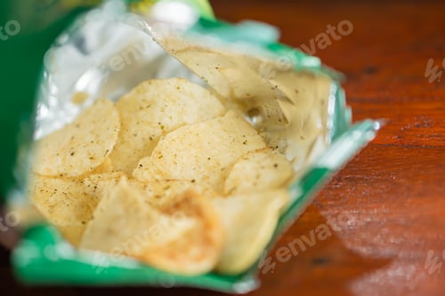 Preview: Open Bag of Potato Chips on Wooden Table