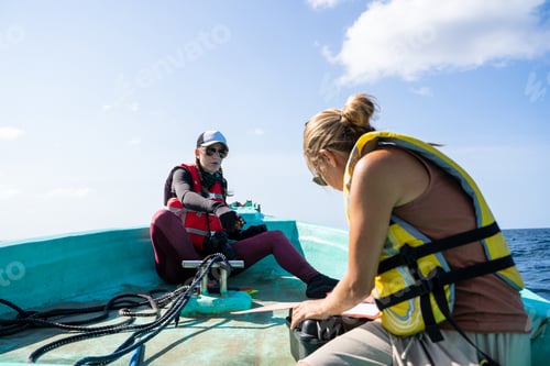Preview: Two marine biologist working on a boat on the sea