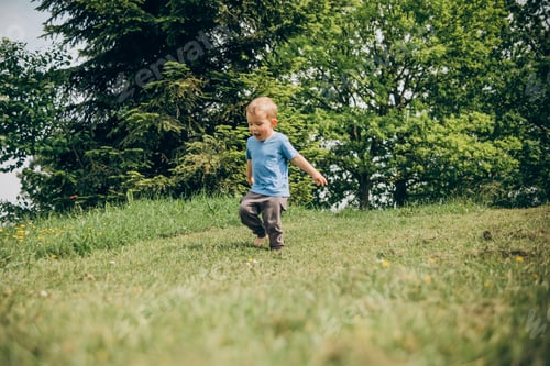 Preview: child running on the green lawn