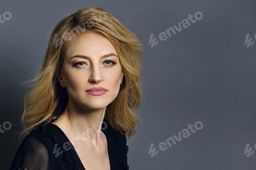 Preview: Close-up studio portrait of a beautiful middle aged blonde woman
