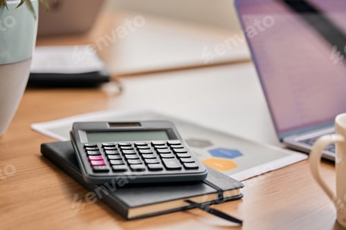 Preview: Still life shot of a calculator and notebook on a desk in an office