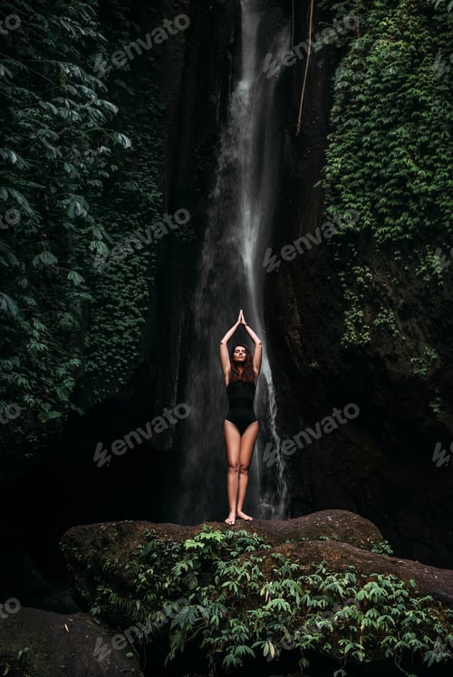 Preview: A woman does yoga at a waterfall. Healthy lifestyle. The concentration of the body